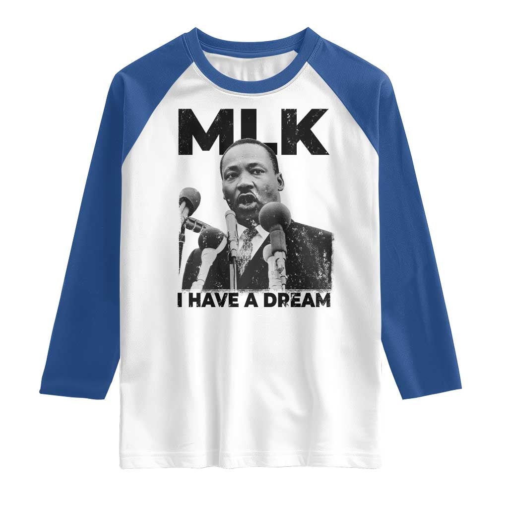 Raglan shirt with white body, blue sleeves, and MLK “I Have a Dream” graphic