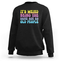 Black crewneck sweatshirt with multicolor 'It's weird' and 'old people' text graphic
