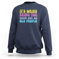 Navy crewneck sweatshirt with multicolor 'It's weird' and 'old people' text graphic