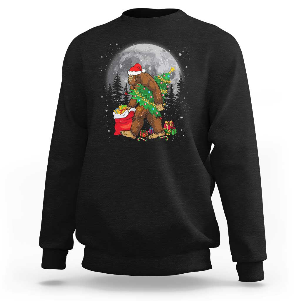 Dark sweatshirt with Bigfoot in Santa hat, green garland, and lit Christmas scene graphic