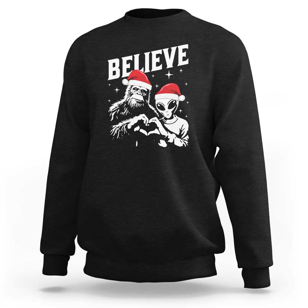 Black crewneck sweatshirt with 'Believe' alien and Bigfoot graphic