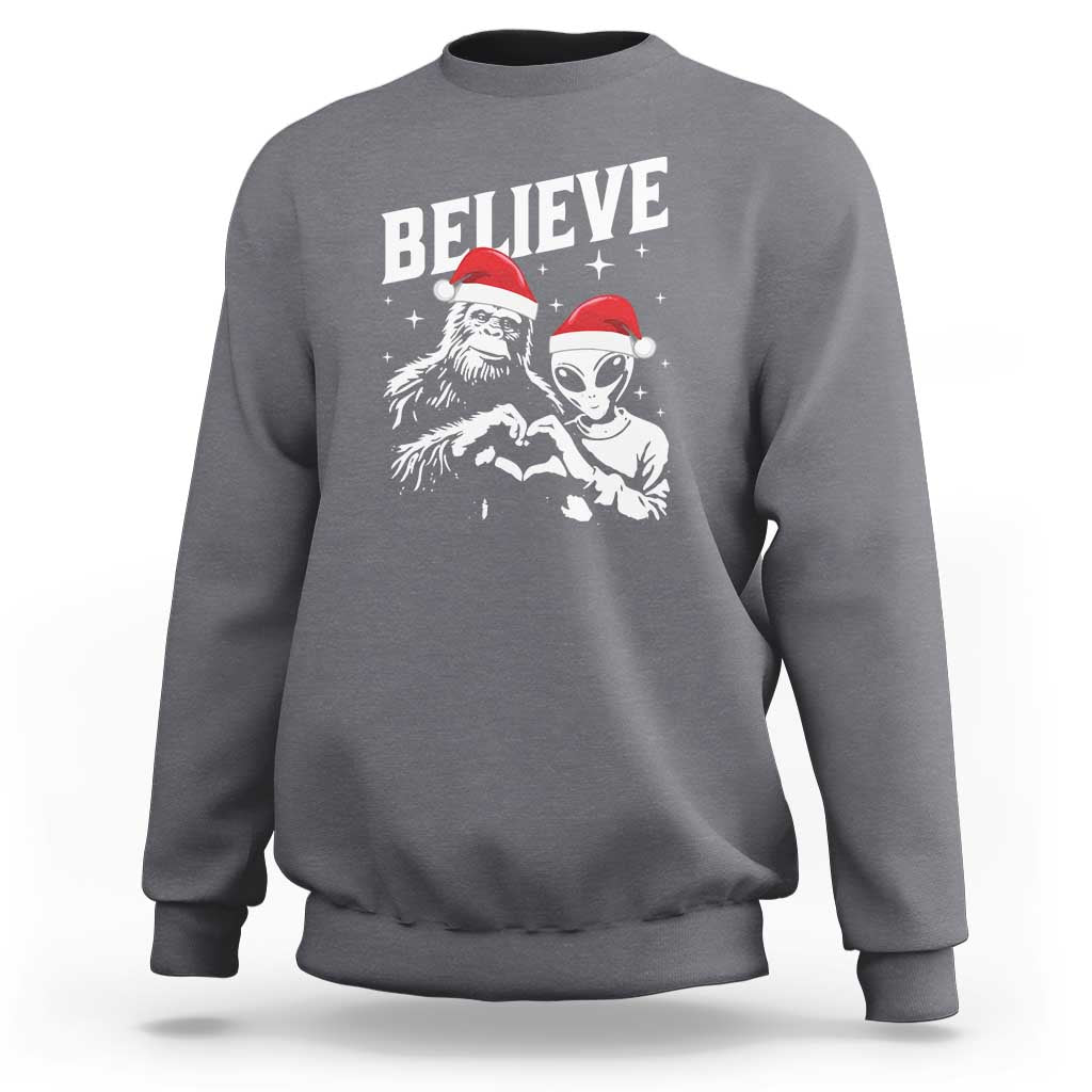 Charcoal crewneck sweatshirt with 'Believe' alien and Bigfoot graphic
