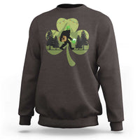 Dark chocolate sweatshirt with Bigfoot graphic holding a green shamrock and clover leaves