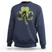 Navy sweatshirt with Bigfoot graphic holding a green shamrock and clover leaves