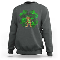 Dark gray crewneck sweatshirt with green shamrock Bigfoot graphic on front