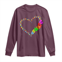 Maroon long-sleeve autism awareness shirt with rainbow heart puzzle graphic