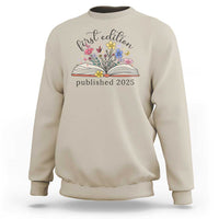 Sand crewneck sweatshirt with floral book stack and “published 2025” front print.