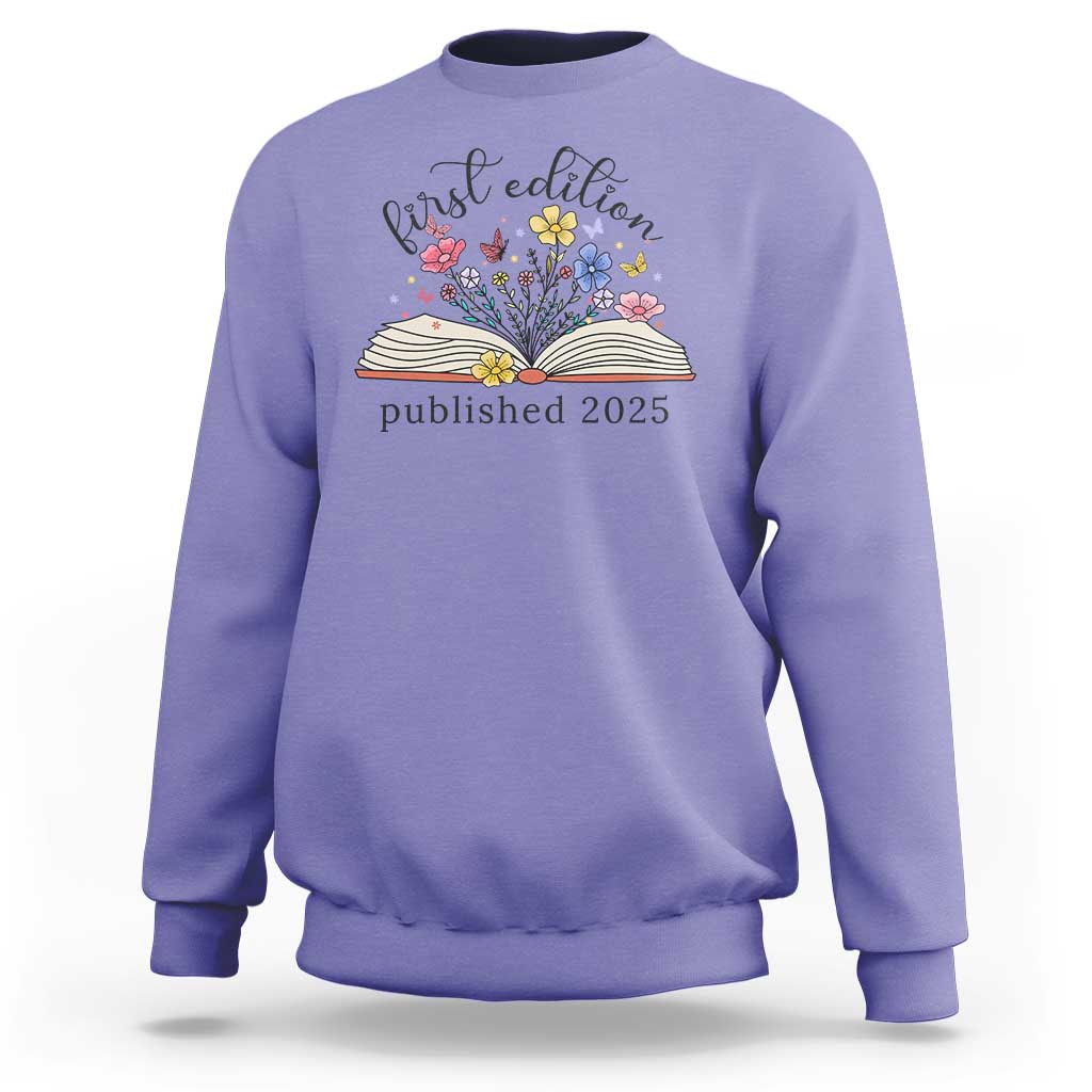 Violet crewneck sweatshirt with floral book stack and “published 2025” front print.
