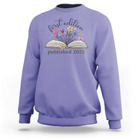 Violet crewneck sweatshirt with floral book stack and “published 2025” front print.