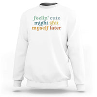 White sweatshirt with front graphic text in green and orange