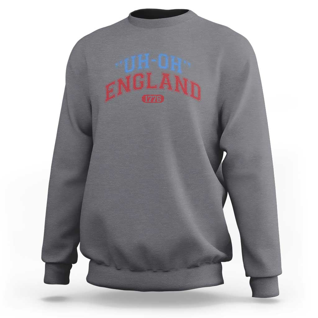 Charcoal gray crewneck sweatshirt with “UH-OH” “ENGLAND” and “1776” graphic