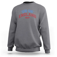 Charcoal gray crewneck sweatshirt with “UH-OH” “ENGLAND” and “1776” graphic