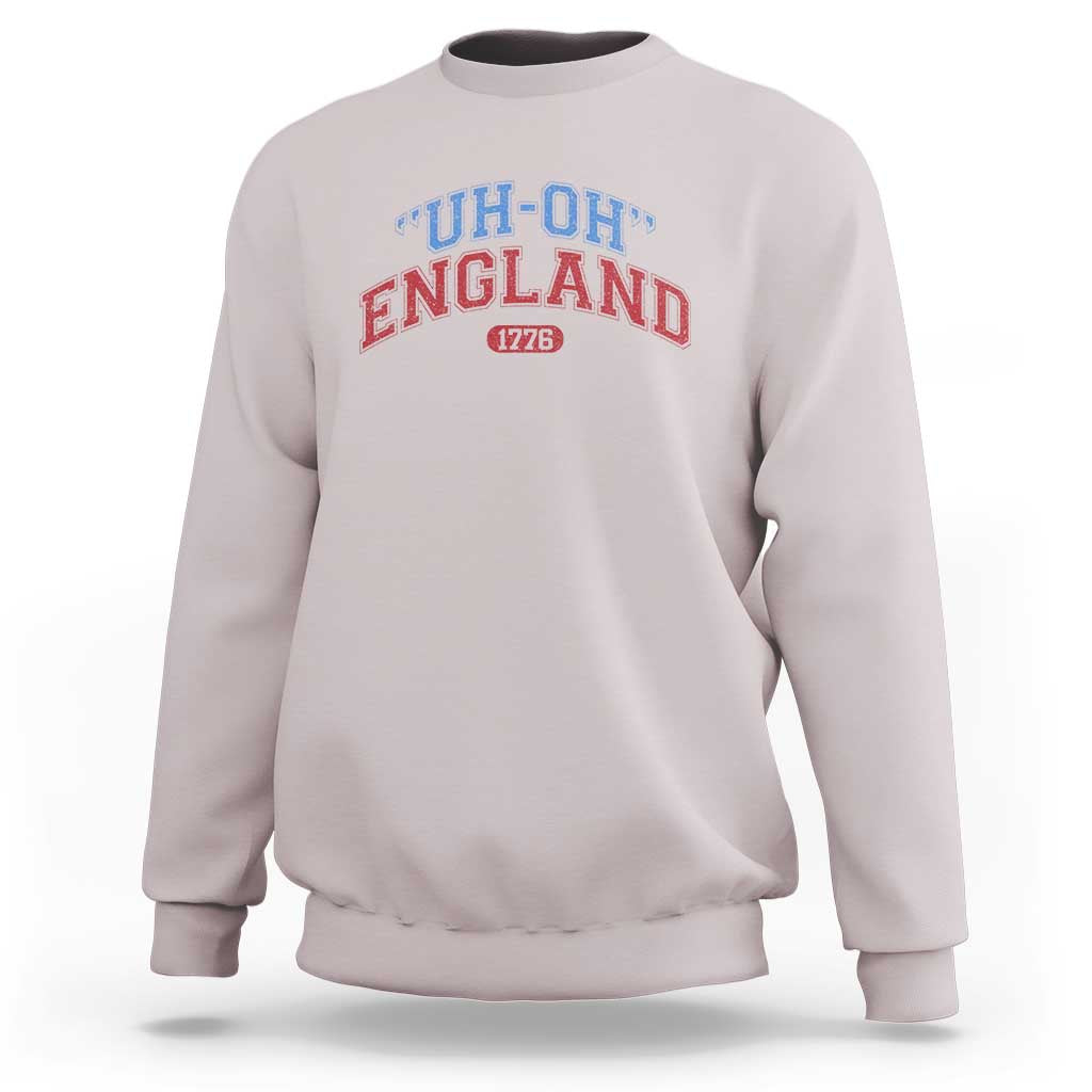 Light gray crewneck sweatshirt with “UH-OH” “ENGLAND” and “1776” graphic
