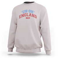 Light gray crewneck sweatshirt with “UH-OH” “ENGLAND” and “1776” graphic