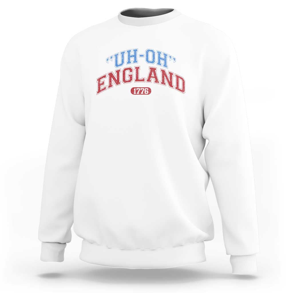 White crewneck sweatshirt with “UH-OH” “ENGLAND” and “1776” graphic on chest