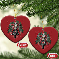Two red heart-shaped motorcycle Santa Christmas ornaments hanging from gold loops