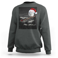 Dark gray-green crewneck sweatshirt with moon-and-Santa graphic across the chest