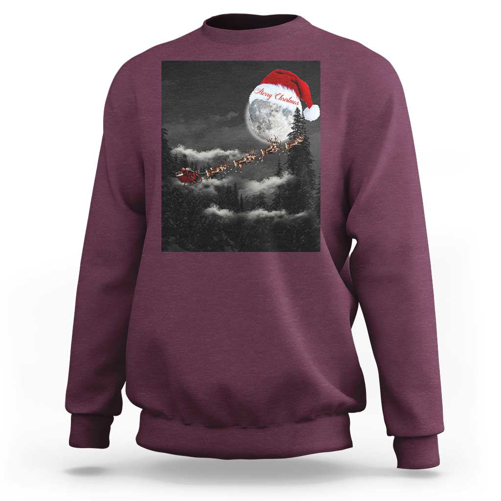 Burgundy crewneck sweatshirt with moon-and-Santa graphic across the chest