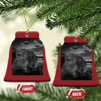 Two red bell-shaped Christmas ornaments with capybara selfie and UFOs, gold hanging loops.