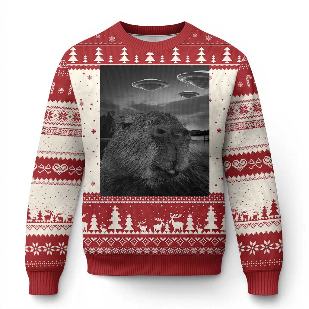 Red ugly Christmas sweater with capybara face graphic, trees, and UFOs print