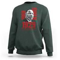 Dark green sweatshirt with large front portrait graphic and red 1929 text, crew neck long sleeves
