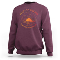 Maroon crewneck sweatshirt with sunrise wave logo graphic