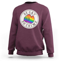Maroon crewneck sweatshirt with circular pride chameleon graphic on chest