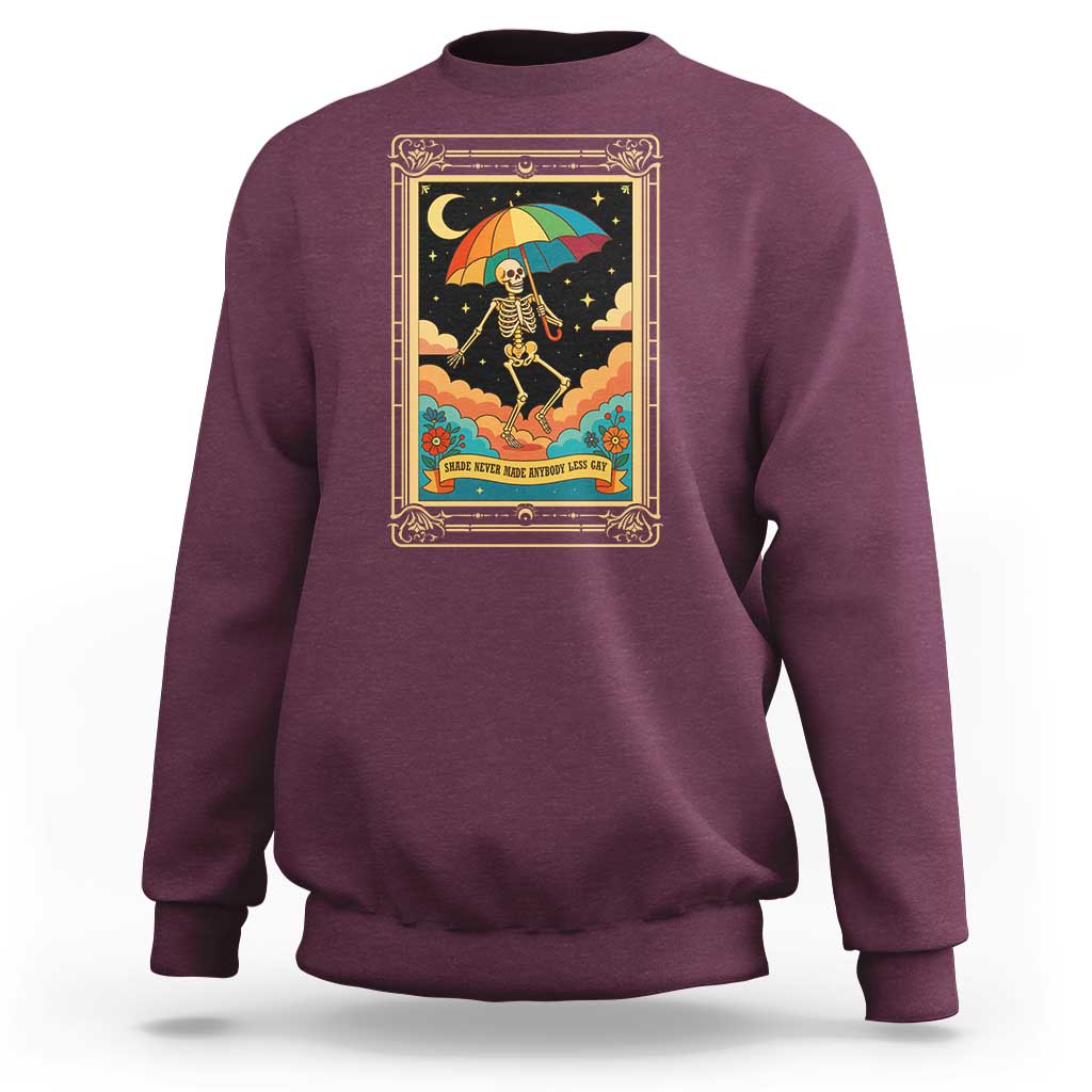 Maroon crewneck sweatshirt with front graphic of rainbow umbrella skeleton and stars