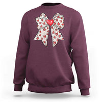 Maroon crewneck sweatshirt with large heart bow graphic on the chest