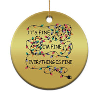 Gold round Christmas ornament with multicolor string-light quote: “It’s fine, I’m fine, everything is fine”.