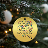 Gold round Christmas ornament hanging from a gold string, with multicolor string-light quote text.