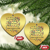 Gold heart-shaped Christmas ornaments (2) with multicolor string-light quote “It’s fine, I’m fine, everything is fine”.
