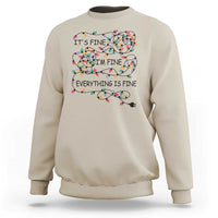 Beige crewneck sweatshirt with festive lightbulb graphic and 'It's fine' text