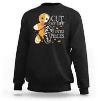 Black crewneck sweatshirt with skull and guitars graphic and “CUT MY LIFE INTO PIECES” text.