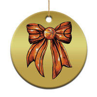 Gold round Christmas ornament with orange ribbon bow design and hanging loop