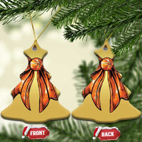 Two gold heart-shaped Christmas ornaments with orange ribbon bow artwork and hanging loop