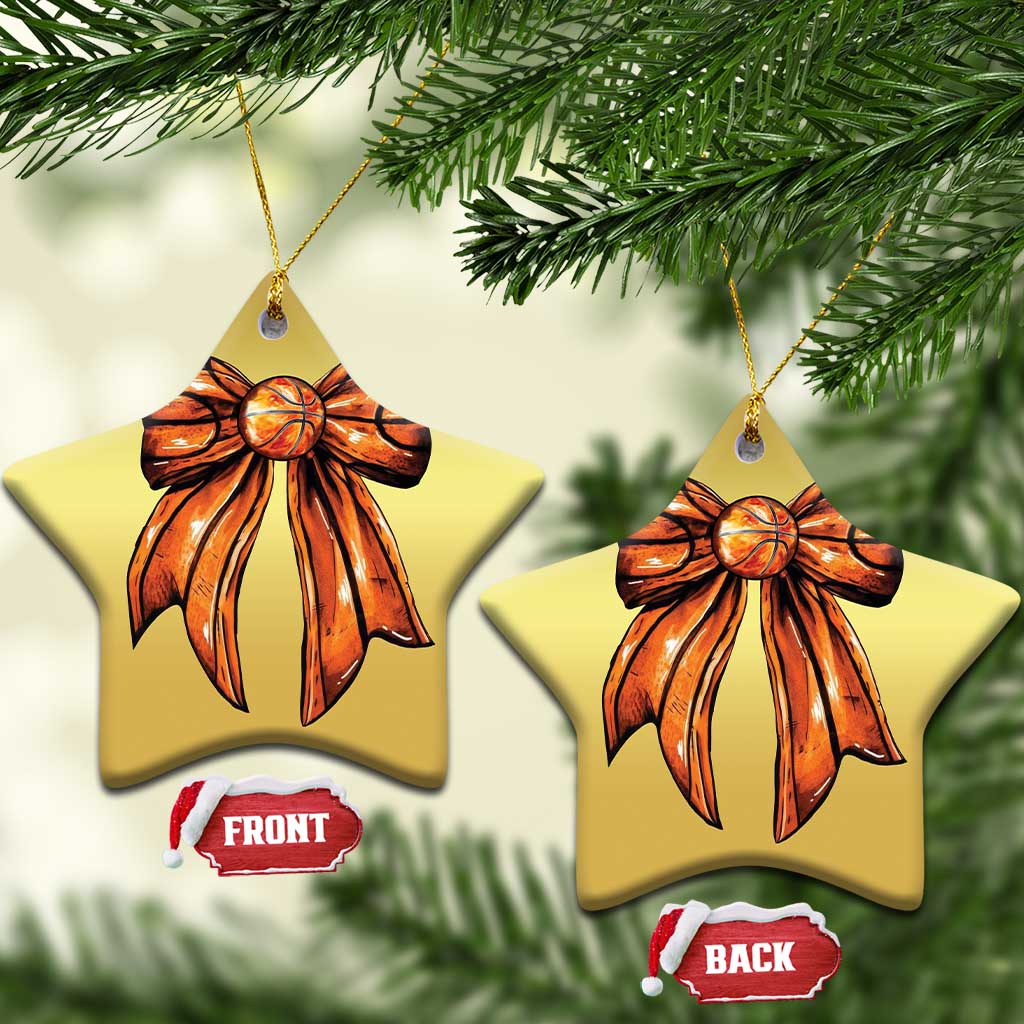 Two gold star-shaped Christmas ornaments with orange ribbon bow design and hanging loop