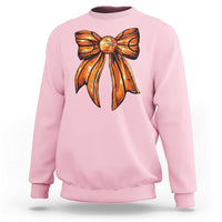 Light pink crewneck sweatshirt with orange basketball bow graphic