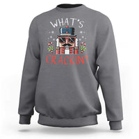 Heather gray crewneck sweatshirt with nutcracker graphic and "What’s Crackin?" text