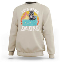 Sand/beige raccoon graphic sweatshirt with “I’M FINE” meme text on front
