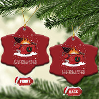 Two red heart-shaped Christmas ornaments with flaming cart graphic and “It’s fine” quote