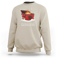 Sand crewneck sweatshirt with festive graphic of burning dumpster and “IT’S FINE, I’M FINE” text