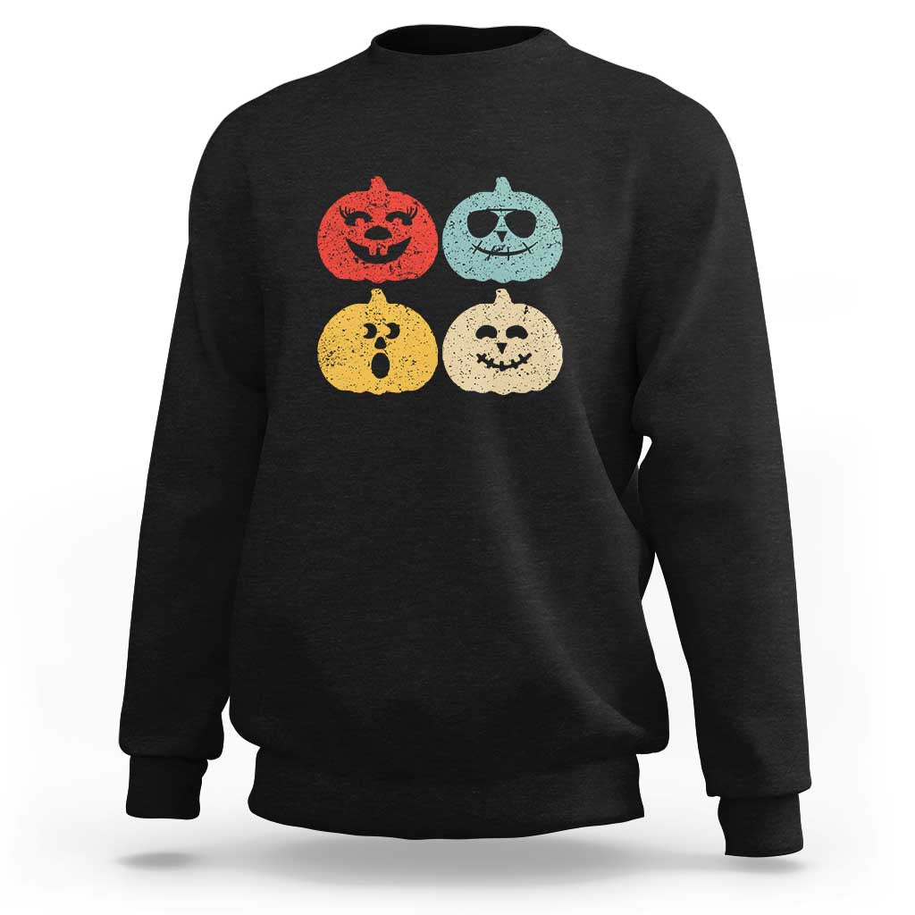 Black Halloween pumpkin graphic sweatshirt with four jack-o'-lantern faces