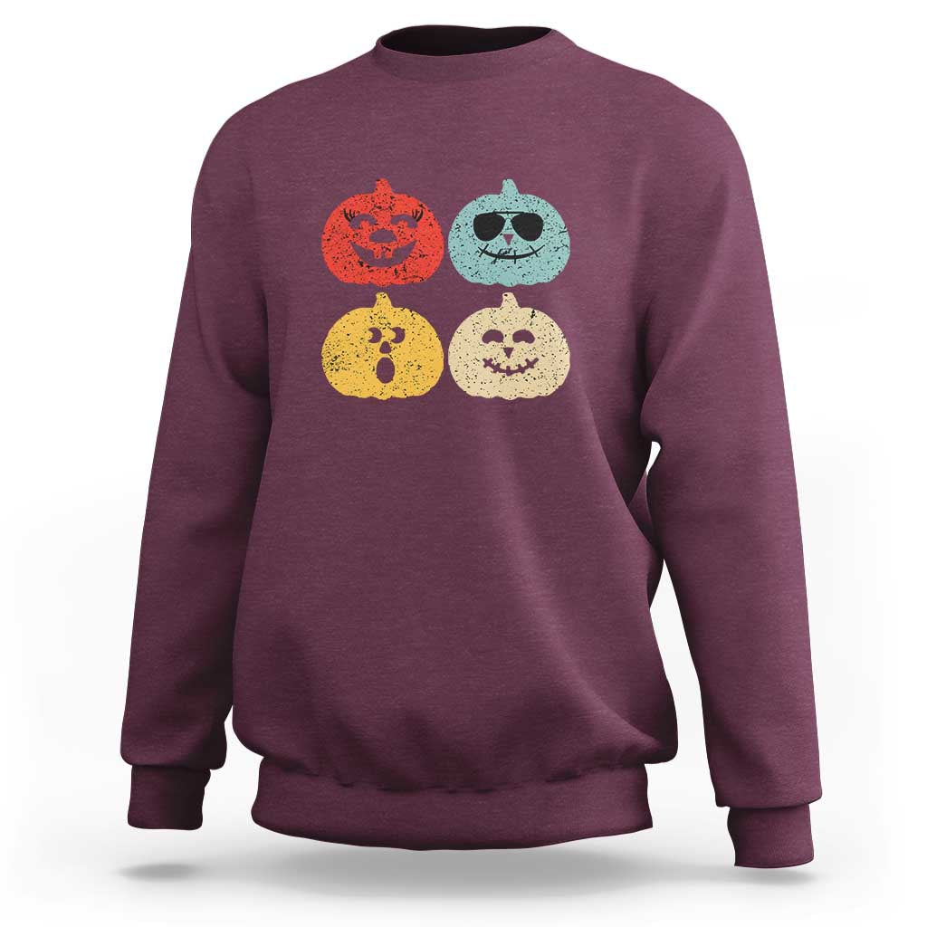 Maroon Halloween pumpkin graphic sweatshirt with four jack-o'-lantern faces
