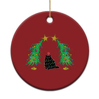Red round cat Christmas ornament with black cat under wreath-like trees and gold stars
