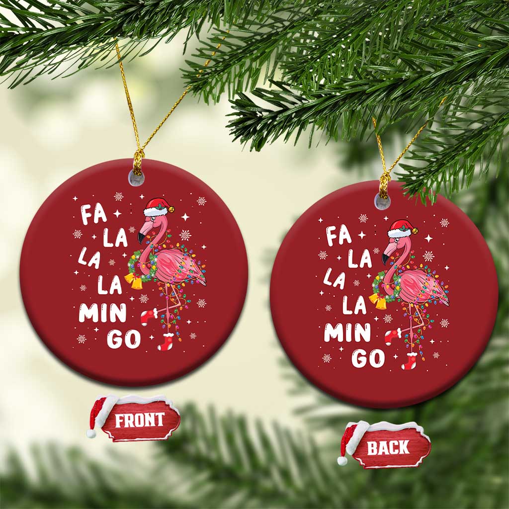 Pair of red round flamingo Christmas ornaments hanging on gold strings with “FA LA LA MIN GO”.