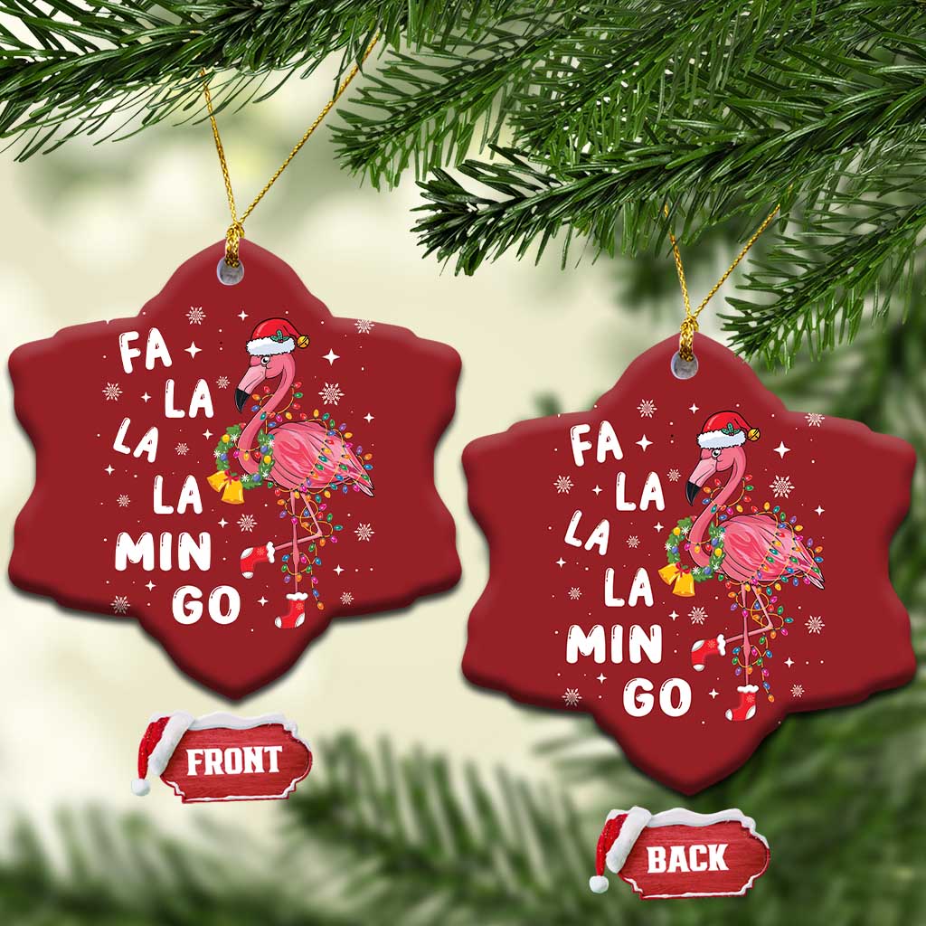 Two red star-shaped flamingo Christmas ornaments with gold strings; “FA LA LA MIN GO” text.