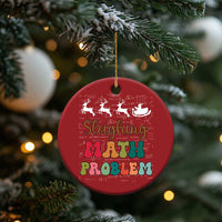 Red round ornament hanging on a Christmas tree with 'Sleighing Math Problem' design