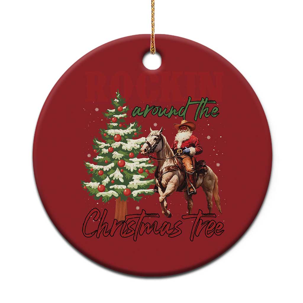 Red round western Christmas ornament with cowboy Santa on horseback and Christmas tree graphic.