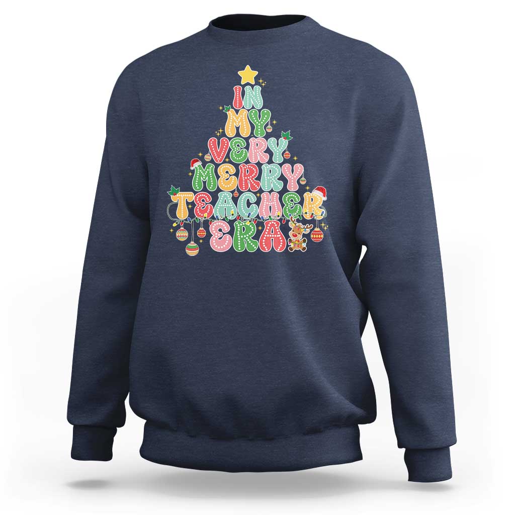 Navy teacher sweatshirt with colorful “Merry Teacher” holiday graphic on front.
